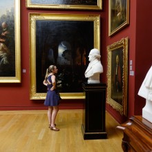 A female student views a statue inside a museum in Paris.