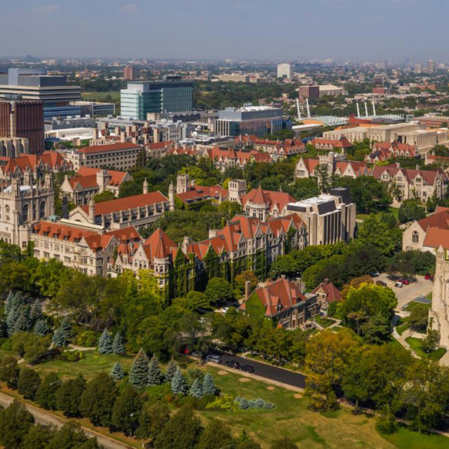 An aerial photo of the University of Chicago campus, trees in a park and a hospital.