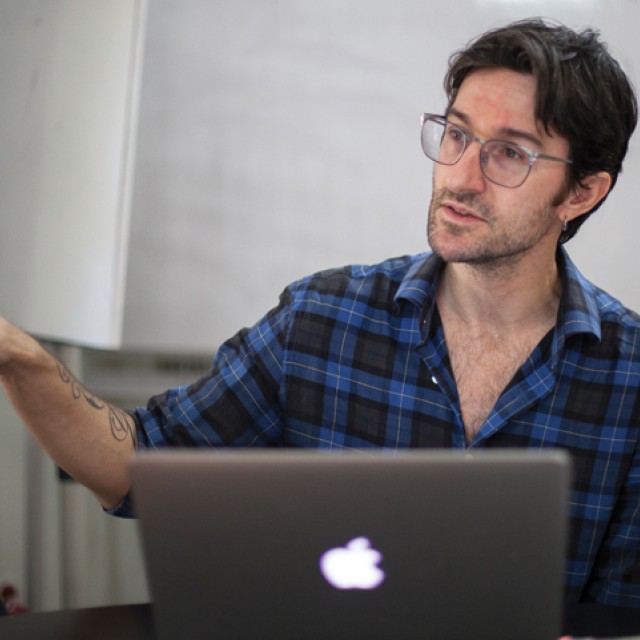 François Richard gesturing as he teaches in a classroom.