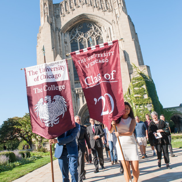 Students hold class of 2020 banners in front of Rockefeller Chapel