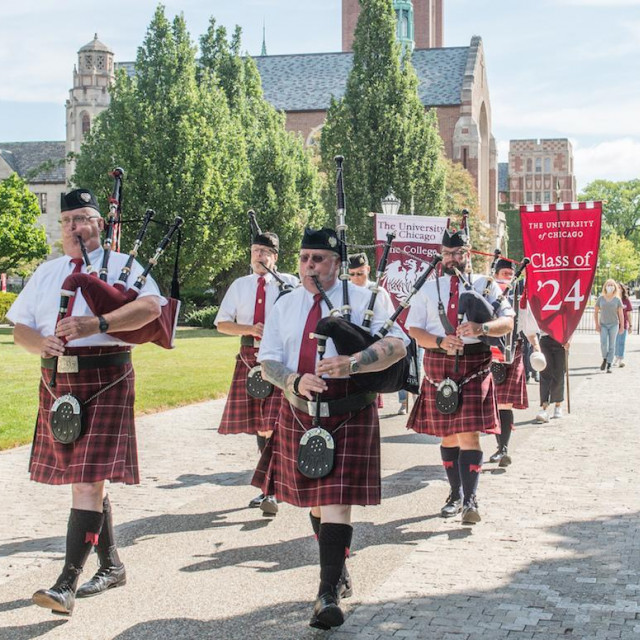 Rows of maroon-clad bagpipers process across the Quad in a socially distant ceremony.