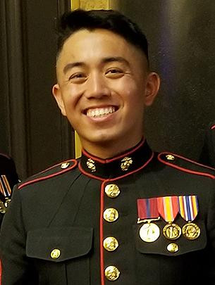 A man wearing a Marine Corps uniform is pictured.