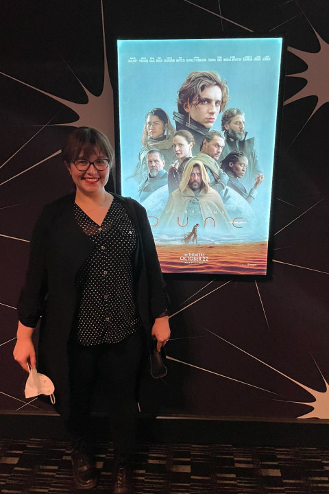 Buse stands next to "Dune" movie poster