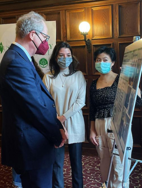 Defne Aksel (center) and Alexandra Kay-Im (right) present the work of PSI’s Environmental Education project group to President Paul Alivisatos during the Sustainability Town Hall on Dec. 1, 2021.