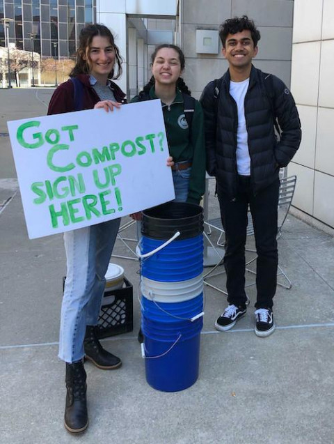 Alex Nobert, Jess Senger and Andre Dang advertise PSI’s composting pilot program outside Renee Granville-Grossman Residential Commons. 