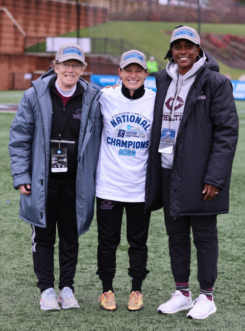 Angie Torain (right) with men's soccer coach Julianne Sitch (center) after last fall's national championship game.