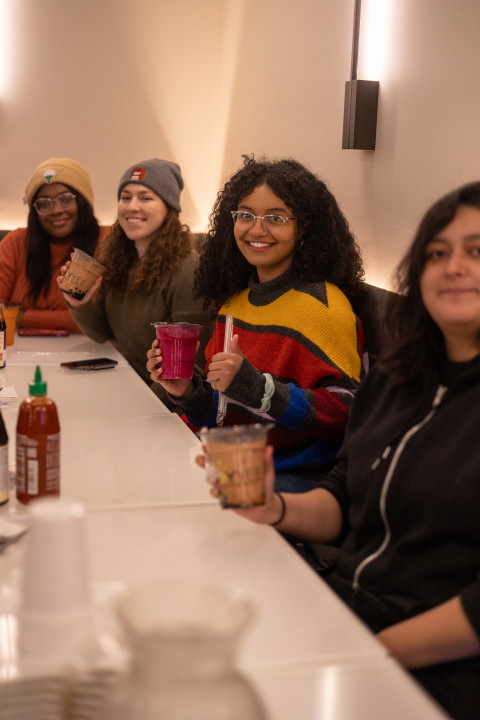 A Maroon Mentors family, including Dymphna Moghalu (back of photo), enjoys bubble tea together.