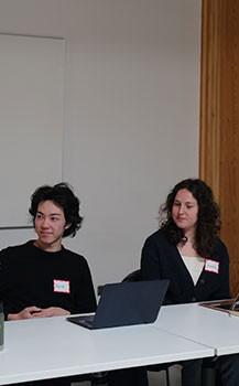 Two students taking part in a panel discussion