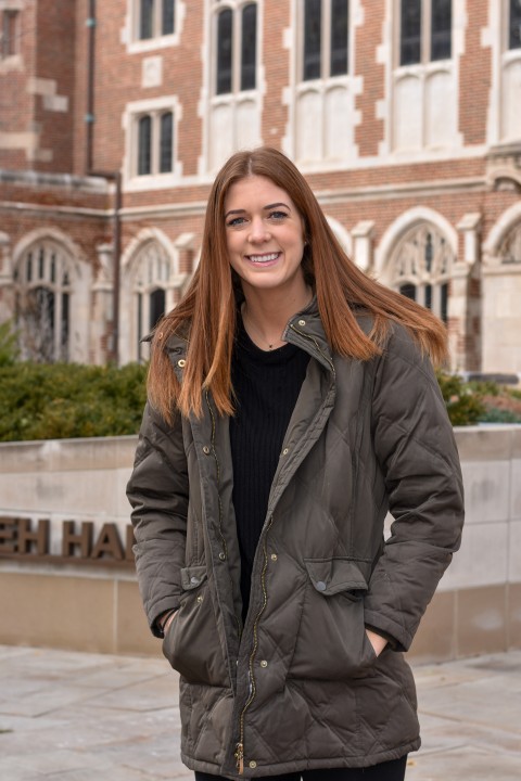 Anna Rose stands in the courtyard outside Saieh Hall.