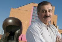 Edward Kolb near the atomic statue outside of Max Palevsky hall.