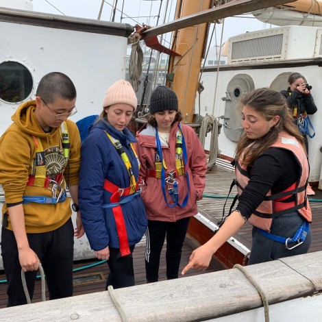 Students on a boat learn to tie knots