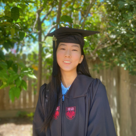 Ihna Yoo portrait outdoors in cap and gown.
